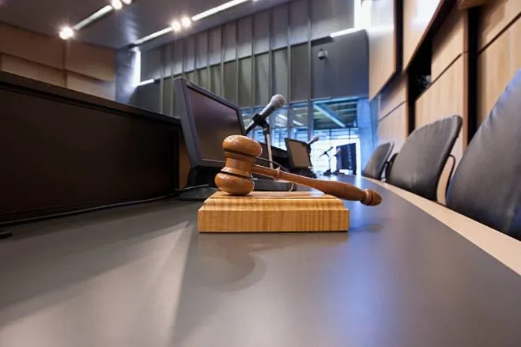 A gavel on the table in a government meeting room.