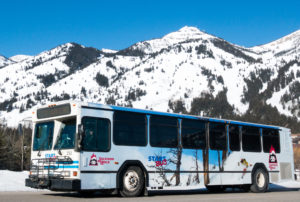 Jackson's START Bus in Teton Village, WY, with a view of the Grand Teton Range.