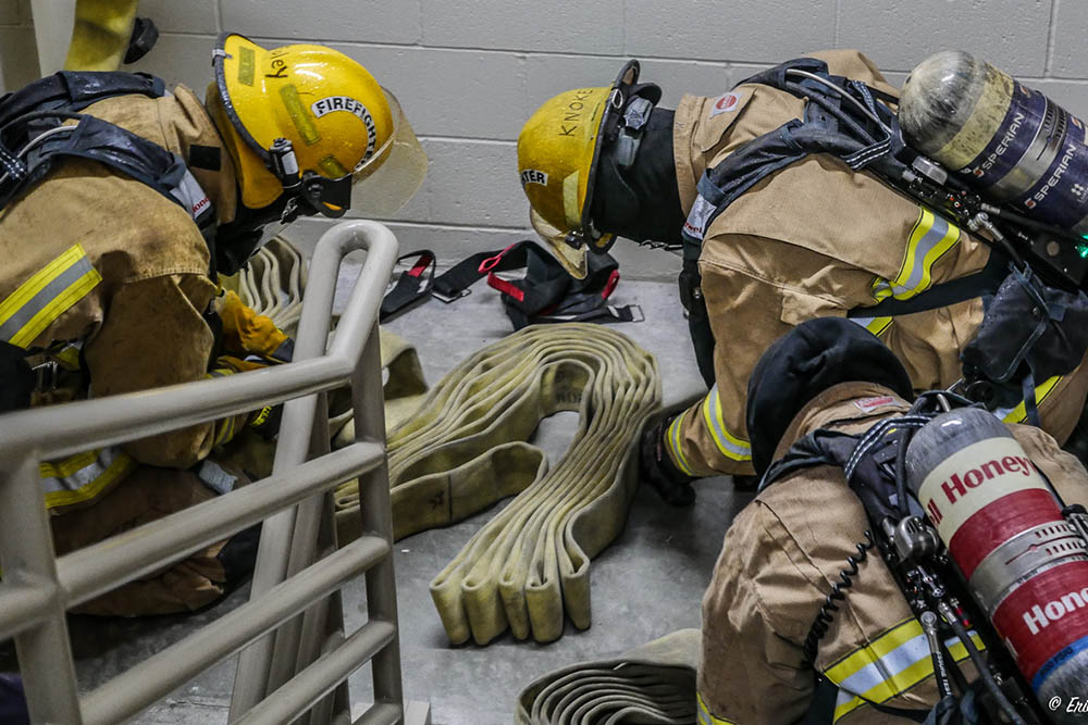 Firefighters work on a fire hose in a stairwell in Teton Village, WY.