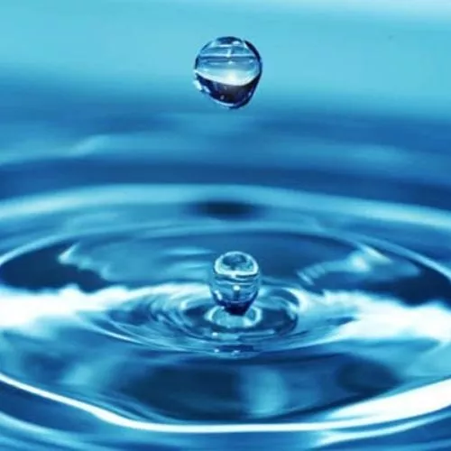 A drop of water causes a splash on the water surface.