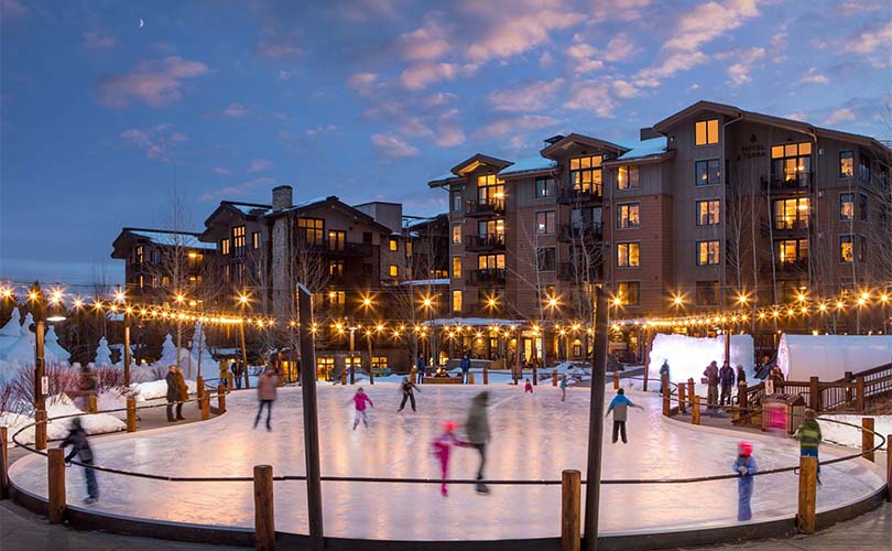 Visitors enjoy ice skating at the Village Rink on the Commons in Teton Village, WY.