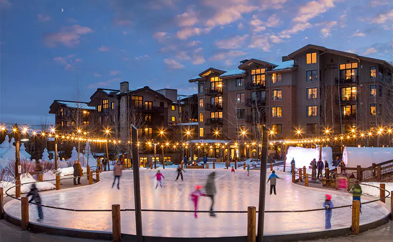 Visitors enjoy ice skating at the Village Rink on the Commons in Teton Village, WY.